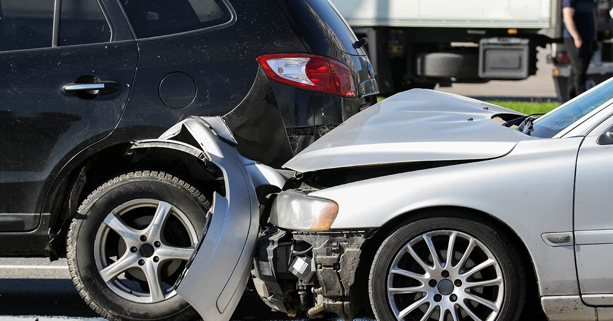 A wall calendar with day 14 circled in red beside car keys and a Florida auto insurance card, showing the Florida PIP 14-day deadline to be seen by a chiropractor after a crash, at Spine and Wellness Center Lakewood Ranch