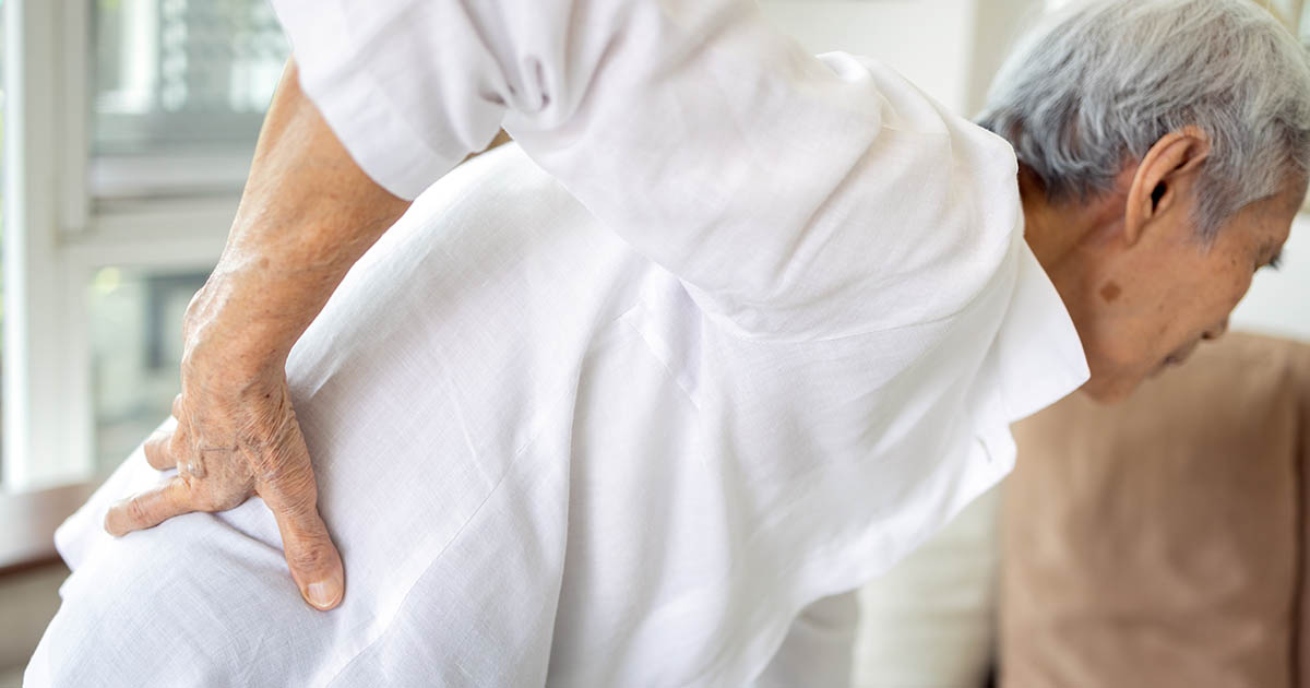 Older adult with osteoarthritis being treated for stiff, achy joints at Spine & Wellness Center Lakewood Ranch
